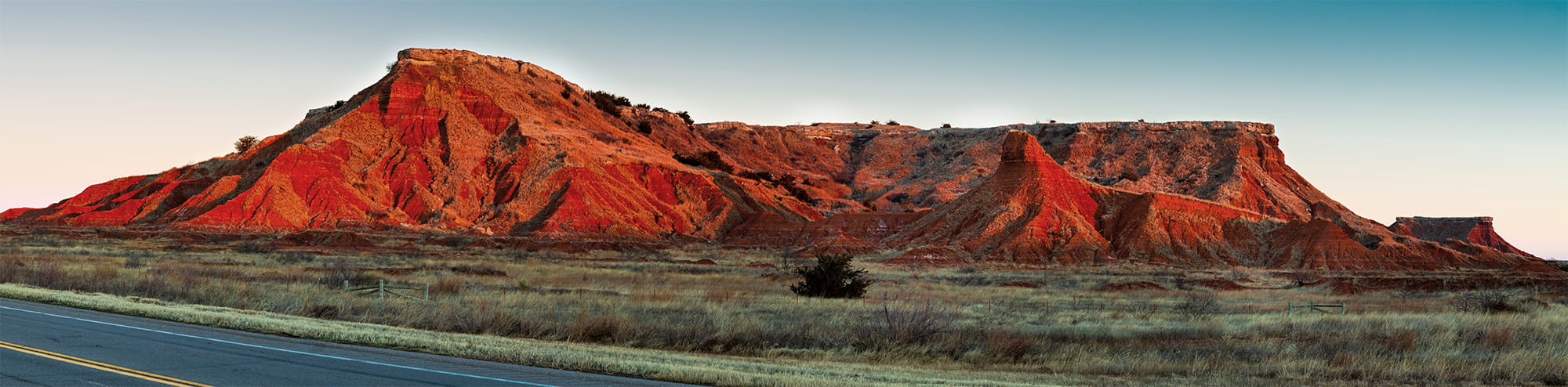 Red clay mesas at dusk in Oklahoma, the landscape that gives Great Plains Recovery its name